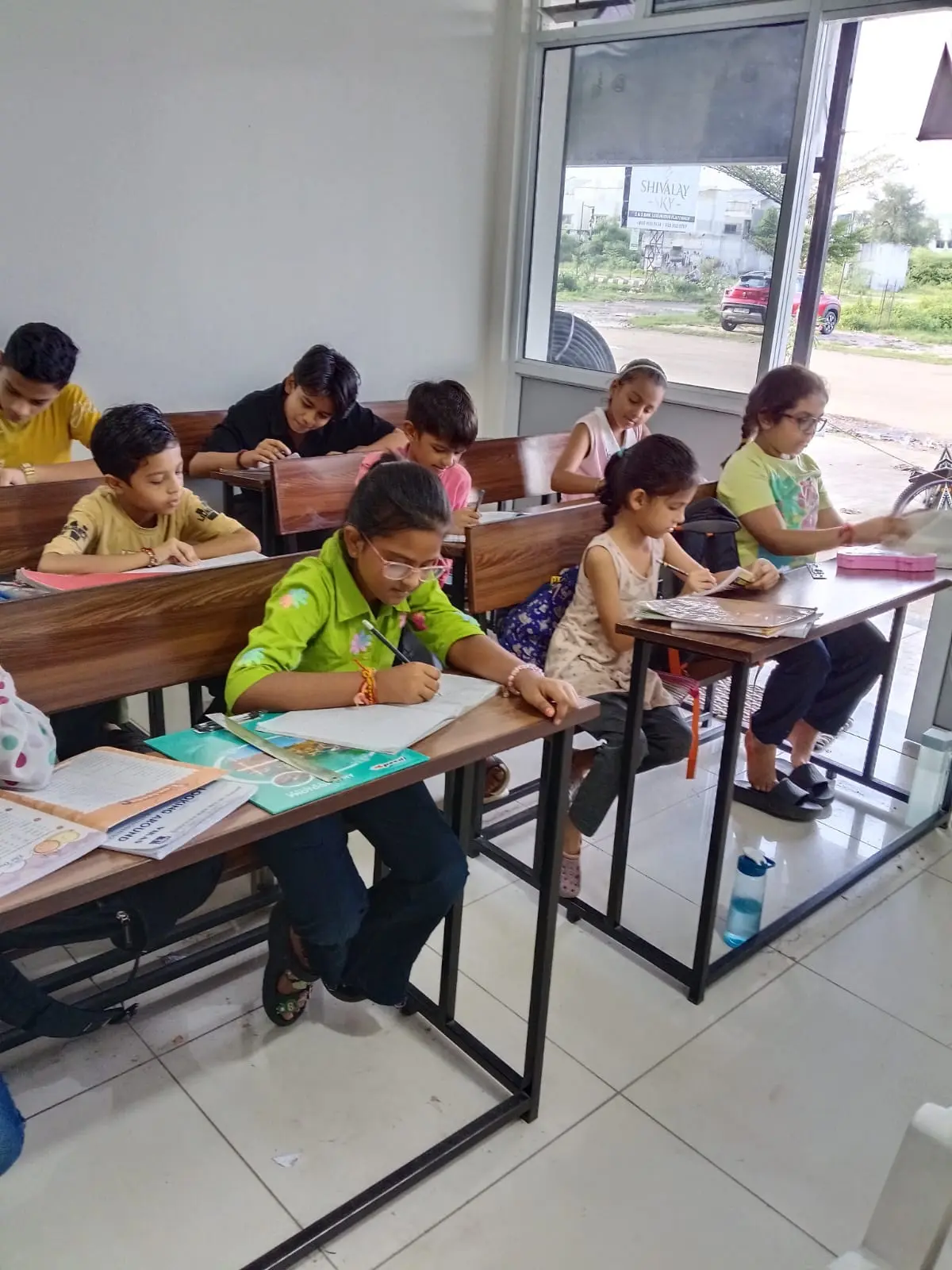 Students working at their desks, side view